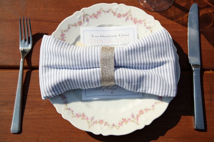 Guests ate off of antique floral patterned china. Stripped linens were made into bows with napkin rings and placed over menu cards at the reception.