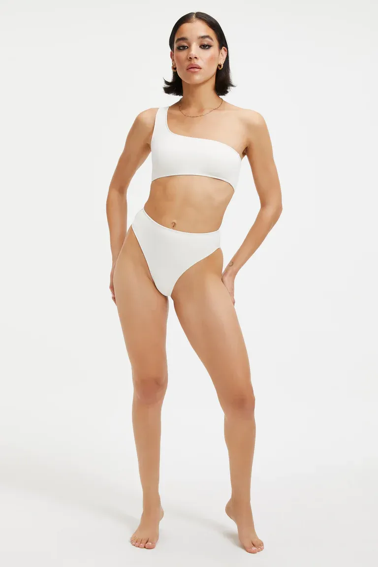 White bikini with one shoulder scoop neck top and high waisted bottoms