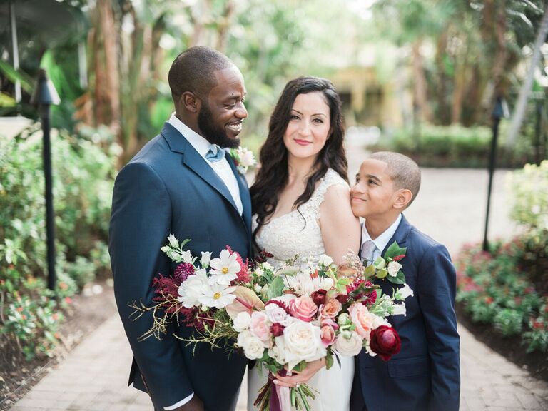 Bride and groom with son at wedding