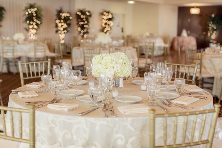 The theme of the wedding was elegant romanticism.   The bride and groom decorated the country club in hues of ivory and white with classy gold accents. The ornate tablecloths were a extra subtle touch.