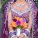 Samantha held a orange, red and purple arrangement of peonies, dahlias and roses.