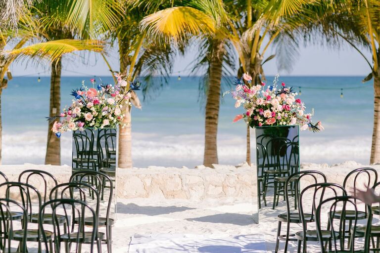 Beach ceremony with mirrored flower pedestals