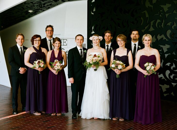 The bridesmaids wore Jenny Yoo's Aidan dresses. Two were Prussian violet and two were plum, and each lady tied the top in whatever neckline she wanted. The groomsmen wore their own black suits and white shirts. Hugo Boss ties and plum pocket squares completed their look to bring the wedding party look together.