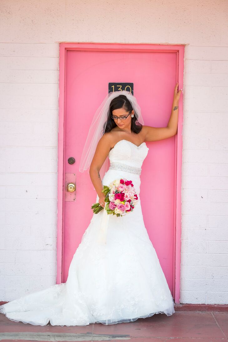 The bride donned a white trumpet style gown by David Tutera, a medium-length veil and light pink pumps.