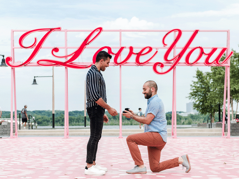 Man on one knee proposing to his fiance. 