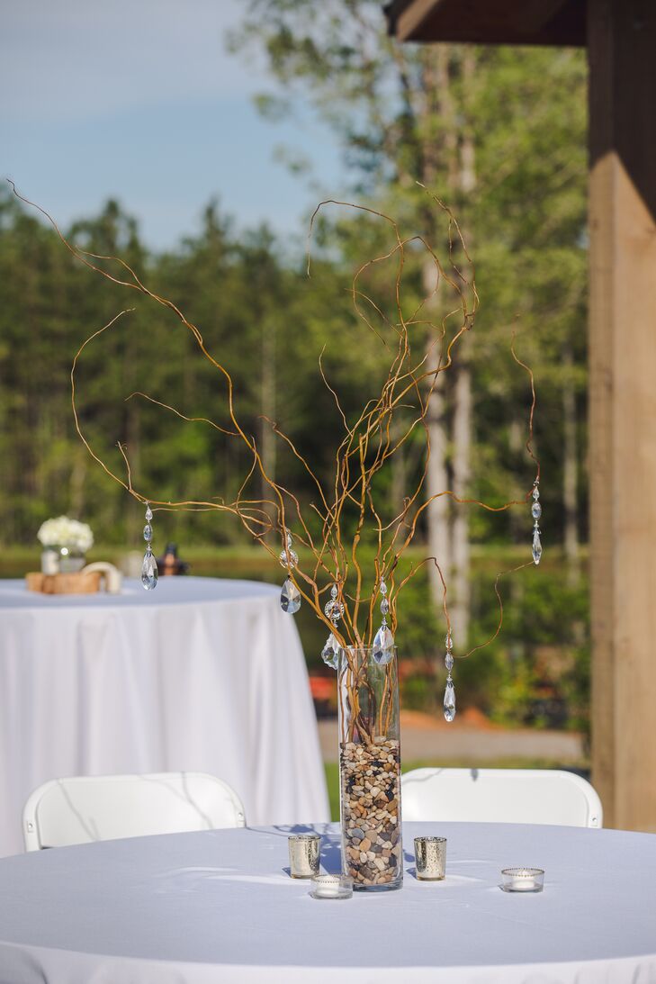 The reception tables were topped with tall glass vases filled with willow branches and pebbles. Meagan and Austin hung crystals from the branches for glamorous flair. The mercury glass candles underneath really made the crystals sparkle!