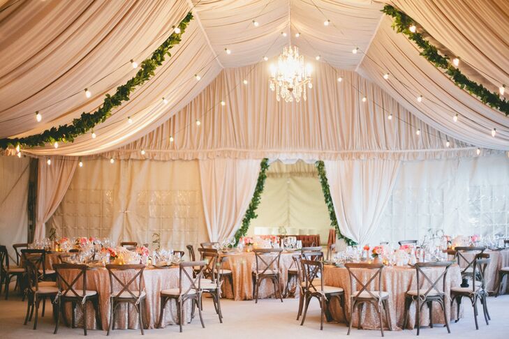 To create an elegant look with a rustic, Italian vibe, the reception tent was draped with airy fabric, lush green garlands and bistro lights. A crystal chandelier added a touch of formality to the space.