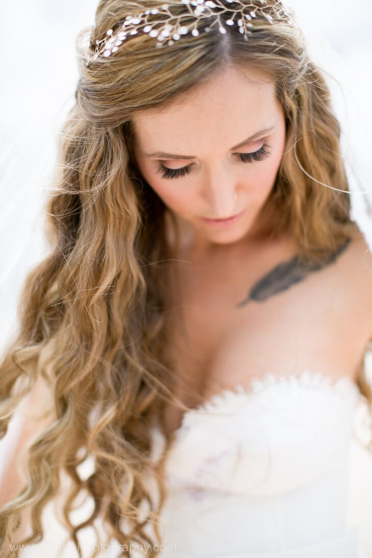 Amanda expanded on her natural and bohemian look by adding a few curls and a floral crown of baby's breath. Her makeup look was natural with full lashes.