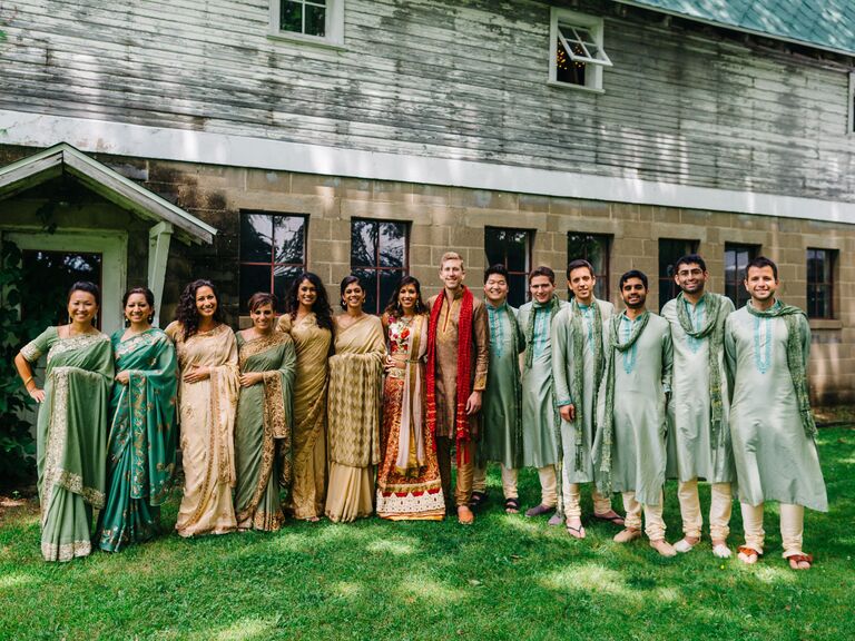 Wedding party photo with all the members wearing different shades of green.