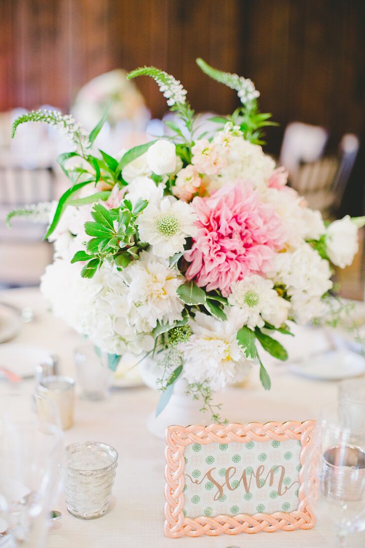To tie into the wedding's rose gold theme, gold script table numbers set against mint polka dot backdrop were framed in rose gold frames.
