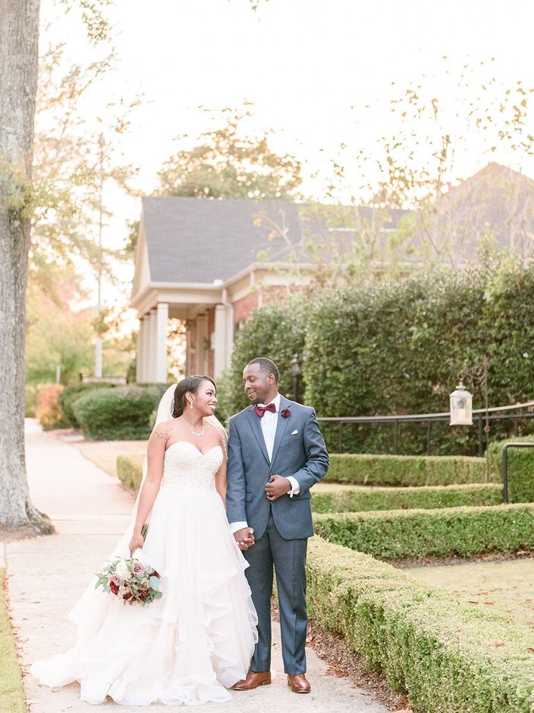 bride and groom walking outside holding hands Alabama