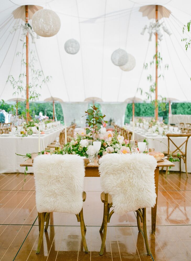 Plush, furry goat pelts covered the couple's chairs at their flower-topped sweetheart table. It overlooked the dance floor and the long feasting tables for their guests.
