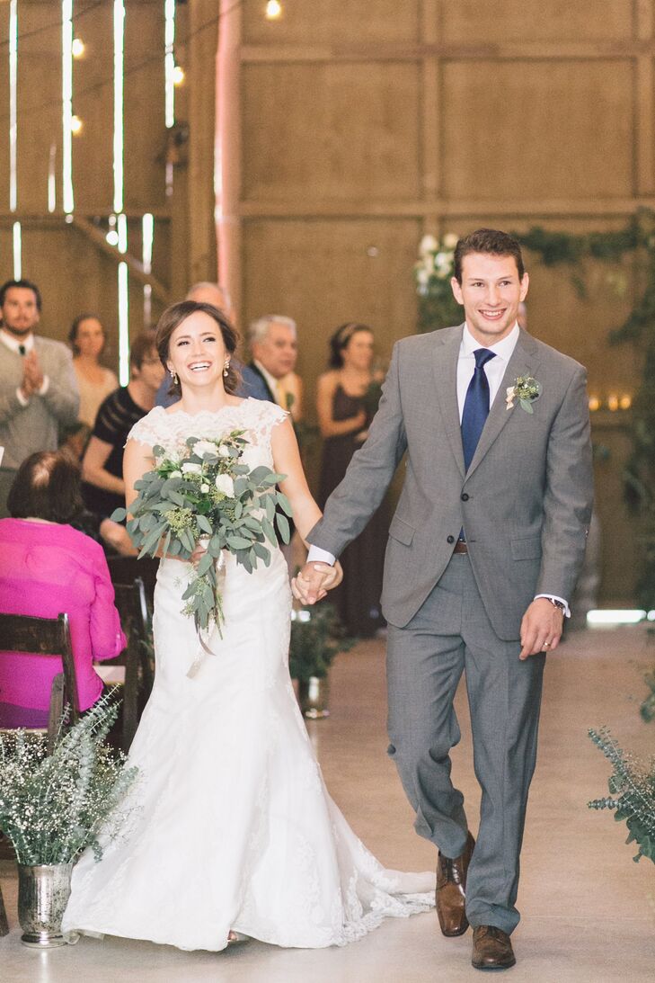 Jeffery had a boutonniere of greens pinned to his light gray jacket, which he wore with matching pants. He wore a navy blue tie to add a pop of color to the neutral-colored outfit. Melanie wore an ivory wedding dress entirely accented with a lace overlay.
