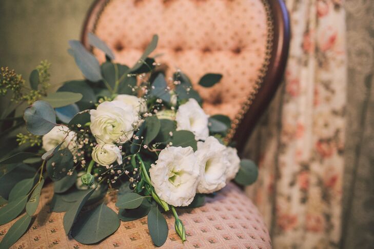 Melanie held a bouquet of greens, such as leaves and eucalyptus, mixed in with scattered ivory flowers. "I love greenery, so we had eucalyptus as the bulk of our floral arrangements with some white added in," Melanie says. "We wanted it to be warm and inviting."