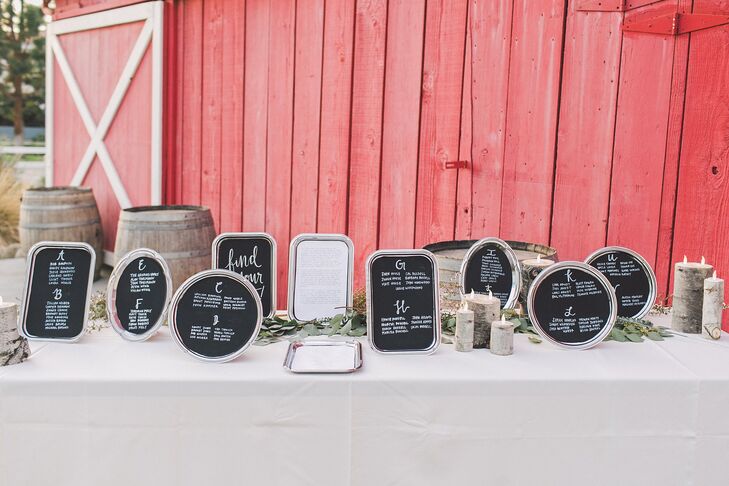 The seating assignments were displayed on small black chalkboards in different shapes bordered by a silver frame, which were located outside the rustic barn at Camarillo Ranch in Camarillo, California.