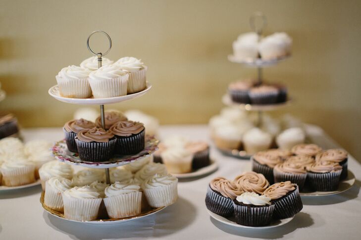 Angela's sisters made over 300 dark or white almond cupcakes on handmade cupcake tiers the bride and groom constructed from vintage souvenir plates.