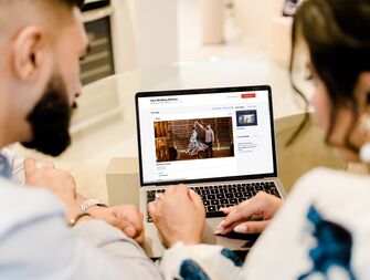 Couple putting drerss code on  wedding website