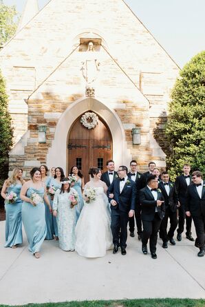 Bride and Groom With Groomsmen in Tuxedos and Bridesmaids in Pale Blue Dresses Outside Church