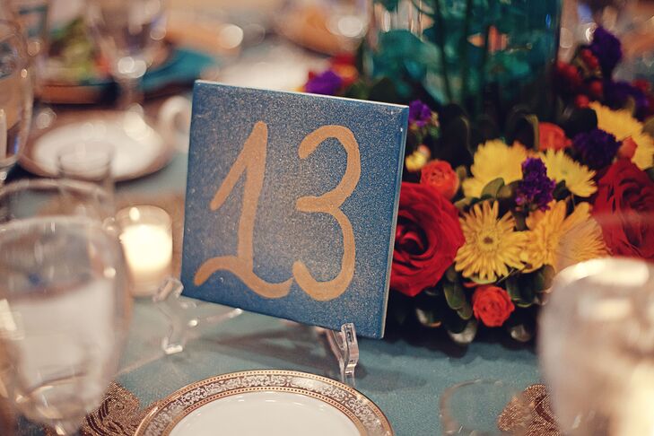 “The tablecloths were teal with gold overlays and the plates were gold and white,” says Ariel. “We painted the table numbers on Spanish tiles, which were teal with gold numbers.”