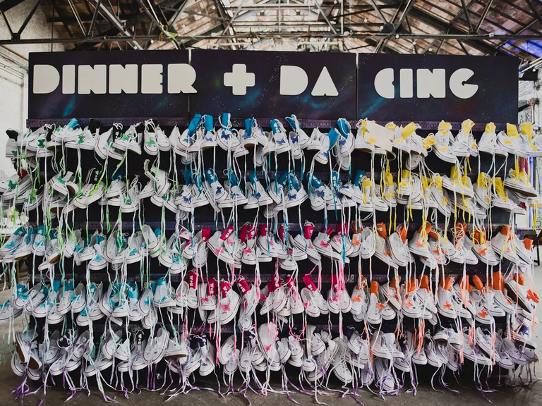 Escort Card and Favor Wall with multicolored canvas sneakers