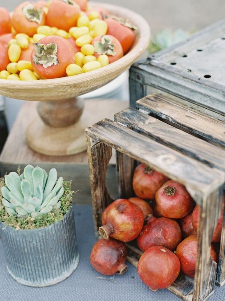 fresh produce centerpiece with persimmons and pomegranates 