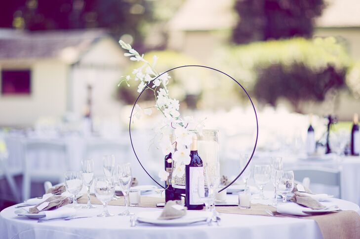 The bride and groom had six different styles of centerpieces. Some included silk  white orchids, silk white hydrangeas, and all had rustic pieces included.