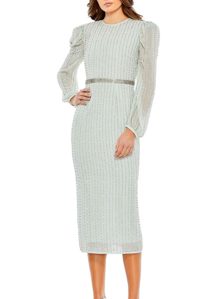 Model wearing mint midi dress with long sleeves and a waistbelt