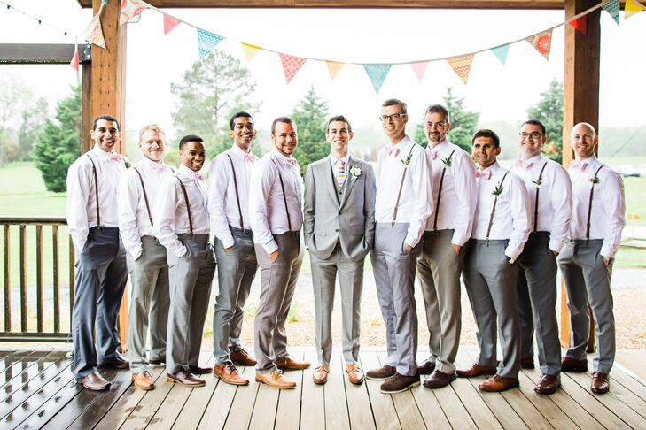 Jake's 10 groomsmen wore their own gray pants with white button-downs and brown shoes. Sophia and Jake's crafty friend hand-stitched all the pink-striped bow ties, and Jake gave each of them leather suspenders to complete the look. Since Jake wanted to stand out a little, he wore a three-piece light gray suit with a colorful striped tie.