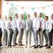 Jake's 10 groomsmen wore their own gray pants with white button-downs and brown shoes. Sophia and Jake's crafty friend hand-stitched all the pink-striped bow ties, and Jake gave each of them leather suspenders to complete the look. Since Jake wanted to stand out a little, he wore a three-piece light gray suit with a colorful striped tie.
