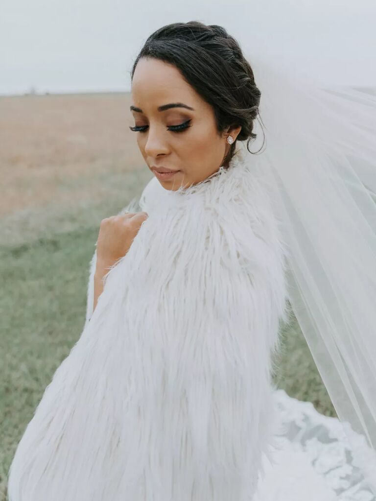 bride wearing white faux fur wedding wrap