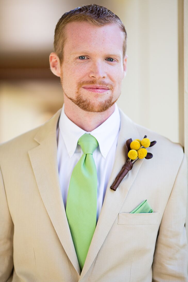 Darryn wore a khaki suit with a bright green tie and matching pocket square. He also wore a boutonniere with craspedia.