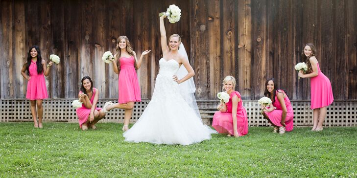 The bridesmaids wore coral dresses with pink undertones from Ann Taylor to play up the coral accents throughout the wedding decor. Each bridesmaid picked out their own style of dress to show off their personality.