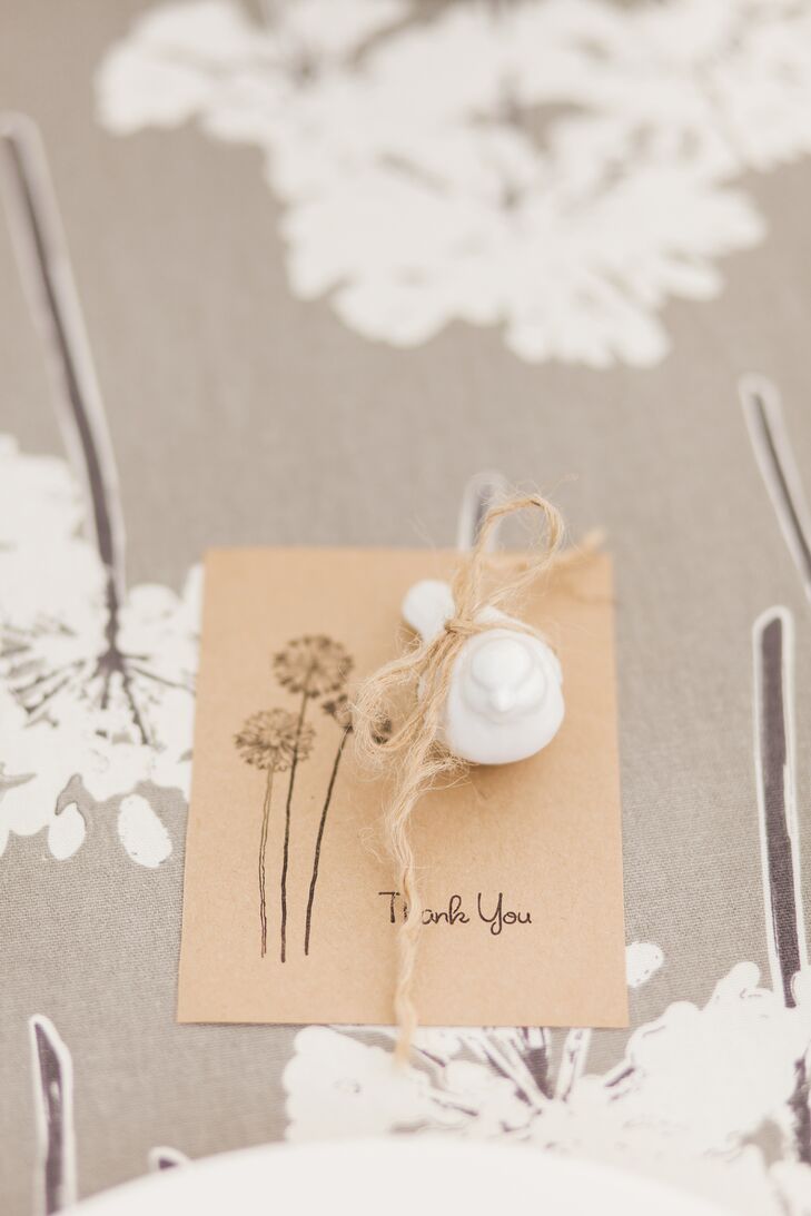 Madison found ceramic bird figurines at a home and garden store and placed one at each place setting to continue the bird theme. They rested on hand-stamped thank-you cards with dandelions to match the table linens.
