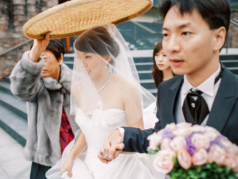 Rice sieve held over bride during wedding