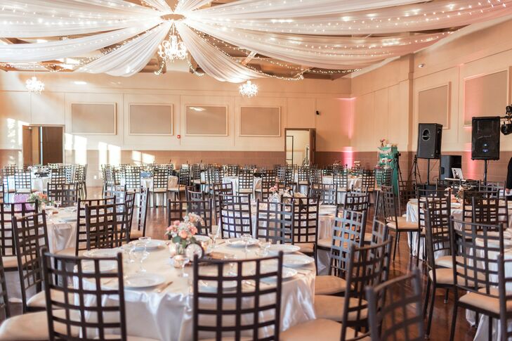 The reception followed in the same room as the ceremony, with a shabby-chic motif throughout the dining tables, each covered in pearly white linens. The ceiling draping with ambient lighting enhanced the ballroom from above.