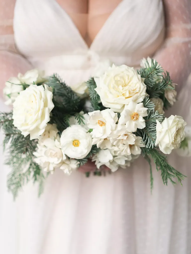 Wintry Bridal Bouquet With White Flowers and Pine and Cedar Greenery