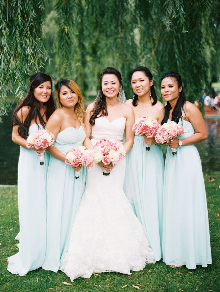 LeiLei set a soft, romantic tone for her bridesmaids’ attire, having the girls don matching Azazie gowns in a pale shade of mint green. The gowns featured strapless, sweetheart necklines to complement LeiLei’s bridal look and floor-length silhouettes, which allowed them to wear shoes of their choosing. They carried classic bunches of roses and carnations down the aisle in shades of pink and ivory, which popped against their pastel gowns.