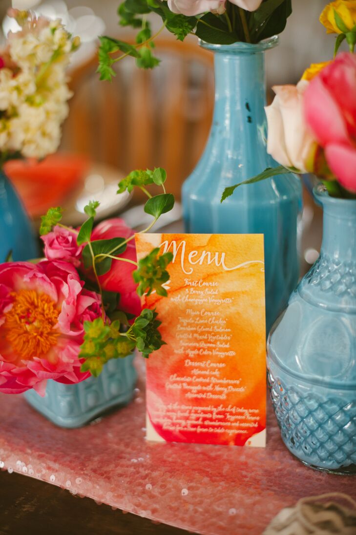 The orange and pink watercolor menu cards gave guests a glimpse of the evening's meal. The bright pieces of stationery had blue vases filled with colorful blooms surrounding it, reflecting the day's garden theme.