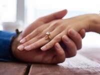 man holding woman's hand 