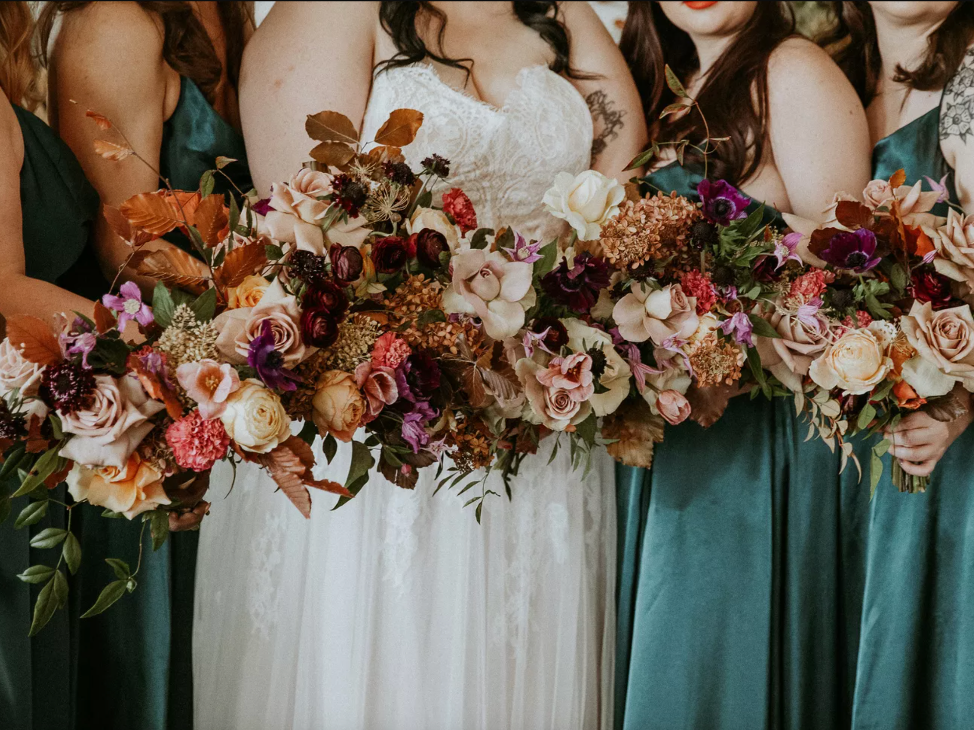 Bridal party holding Rustic Fall Jewel Tone Bouquets With Leaves, Roses and Viburnum