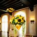 The couple decorated their reception tables with colorful arrangements of yellow garden roses, sunflowers and succulents above floating lemons.