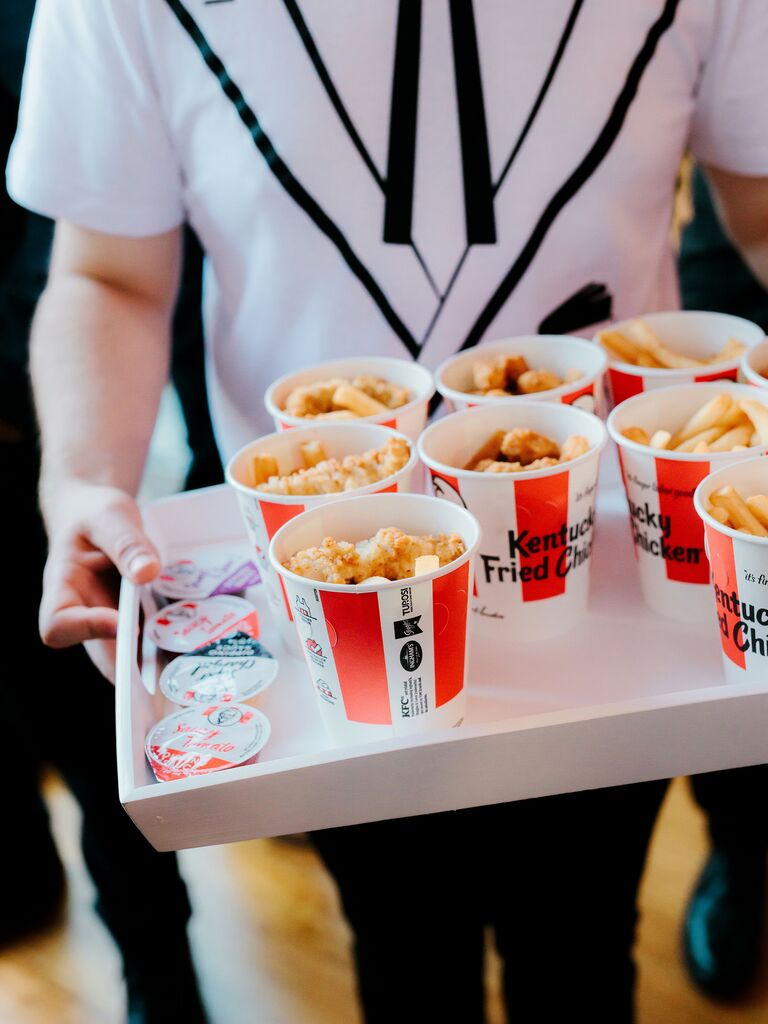 Waiter holding a tray of Kentucky Fried Chicken.