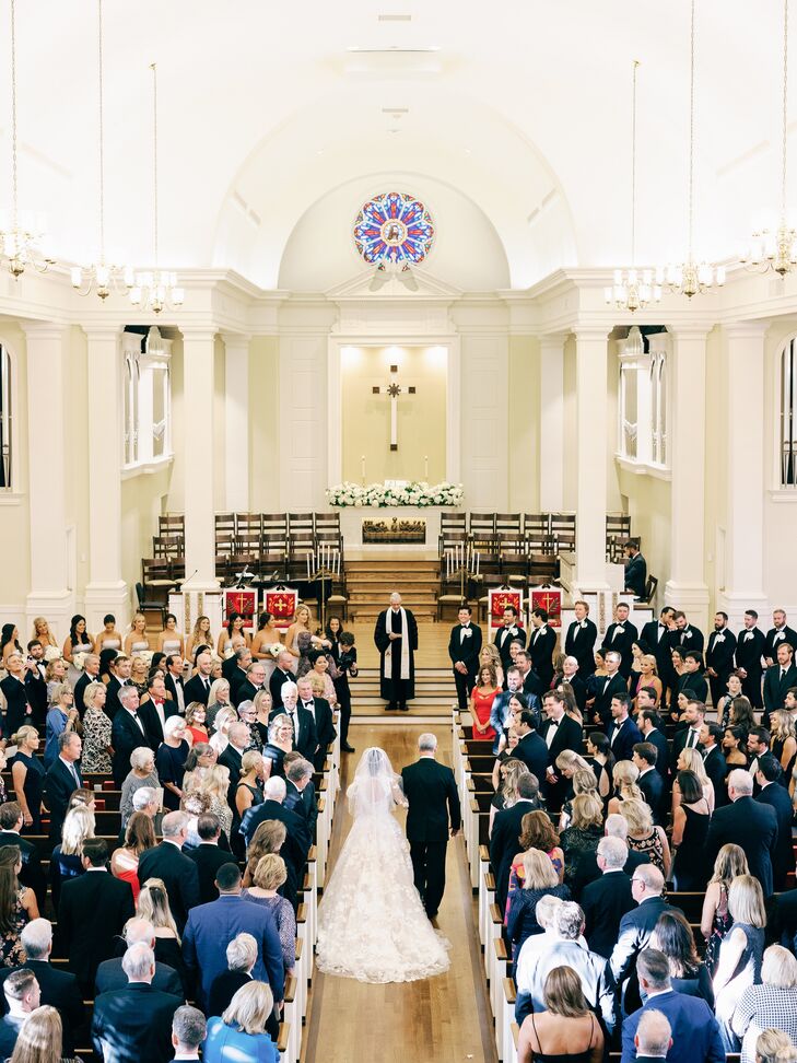 Father Walks Bride Down the Church Aisle With Guests in Pews