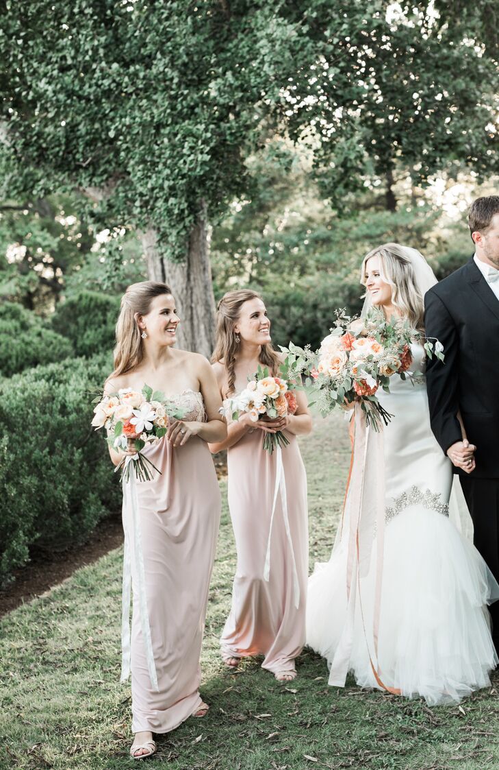Bonnie's two bridesmaids, her sisters, wore blush-hued strapless gowns with a gold embellishment at the bustline.