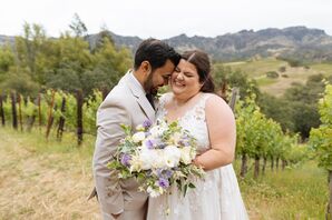 Bride With White and Lavender Bouquet and Groom in Gray Tuxedo at Vineyard