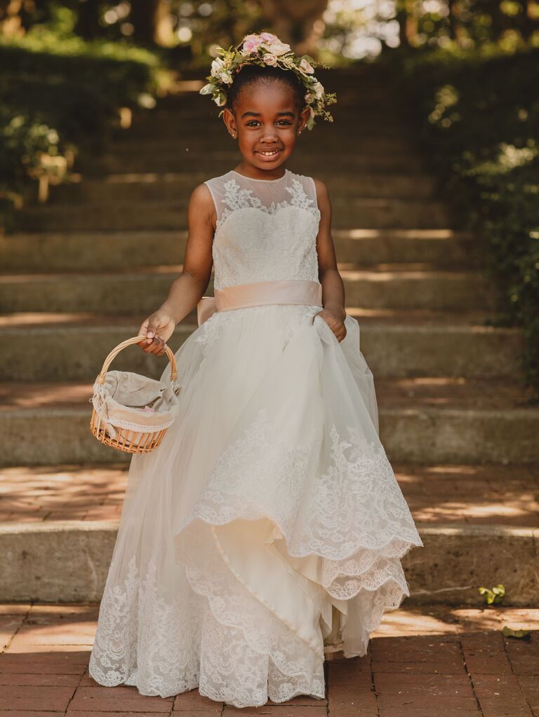 Flower girl poses for wedding party photo shoot.