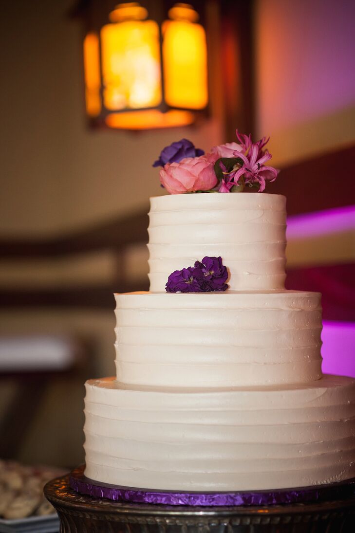 The three-tier white cake had a simple design, accented with pink and purple blooms on the sides and top. The layers had flavors of vanilla cream with fresh strawberries, chocolate chip with Bavarian cream and red velvet with cream cheese. "We decided to keep the decorations and design of the cake to a minimum, so we could also have a Star Wars-themed groom's cake," Cassandra says. "The money we saved also allowed us to have pecan bars, chocolate chip cookies and powered shortbread cookies."