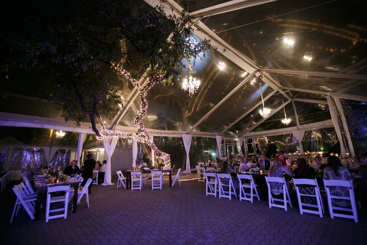 The reception took place under a clear tent in the courtyard at the Allan House in Austin, Texas, with crystal chandeliers overhead and a tree covered in string lights creating a soft glow. Having farm tables were a must for Faith, who wanted her reception to feel like a huge family dinner.