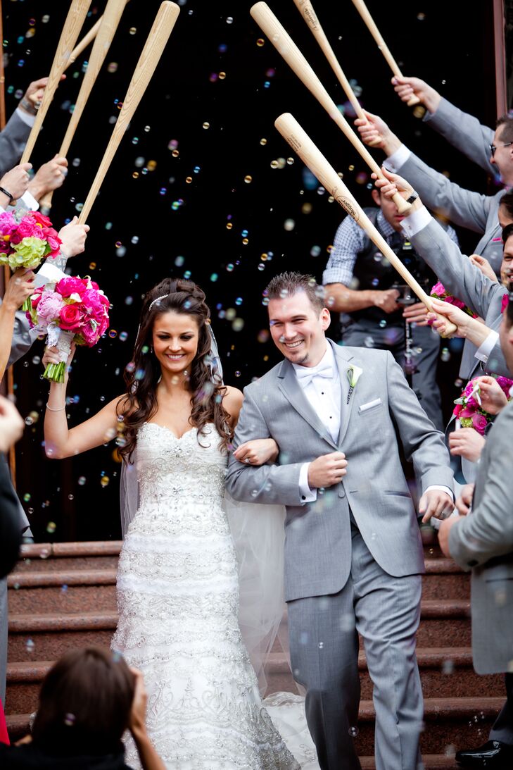 Since Ryan is a big baseball fan, his groomsmen sent the happy couple off to a baseball bat salute while the bridesmaids blew festive bubbles.