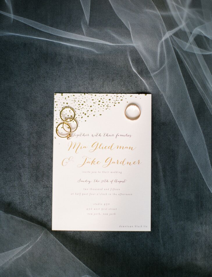 Mia and Jake’s color scheme made its first appearance in the invitations—ivory card stock decked out in gold-foil script and a gold confetti motif. “We used Minted.com to design our invitations and customized a specific collection to fit our design,” Mia says. “We contacted the original designer and had her create a custom large canvas that had the gold-speckled design for our ketubah, which our good friend Michael wrote by hand.”